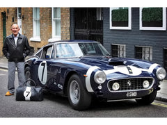 Sir Stirling Moss poses with his Ferrari 250 GT Berlinetta